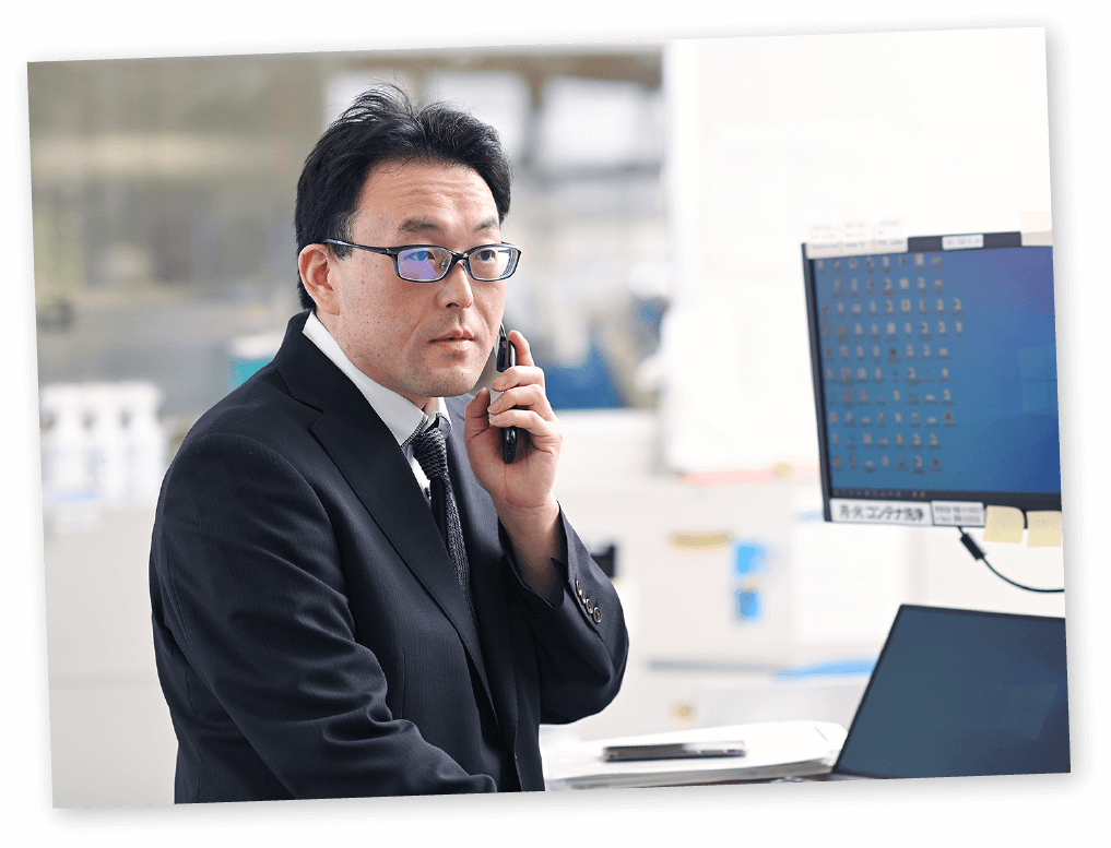 パソコンの前で電話をするM・Tさん